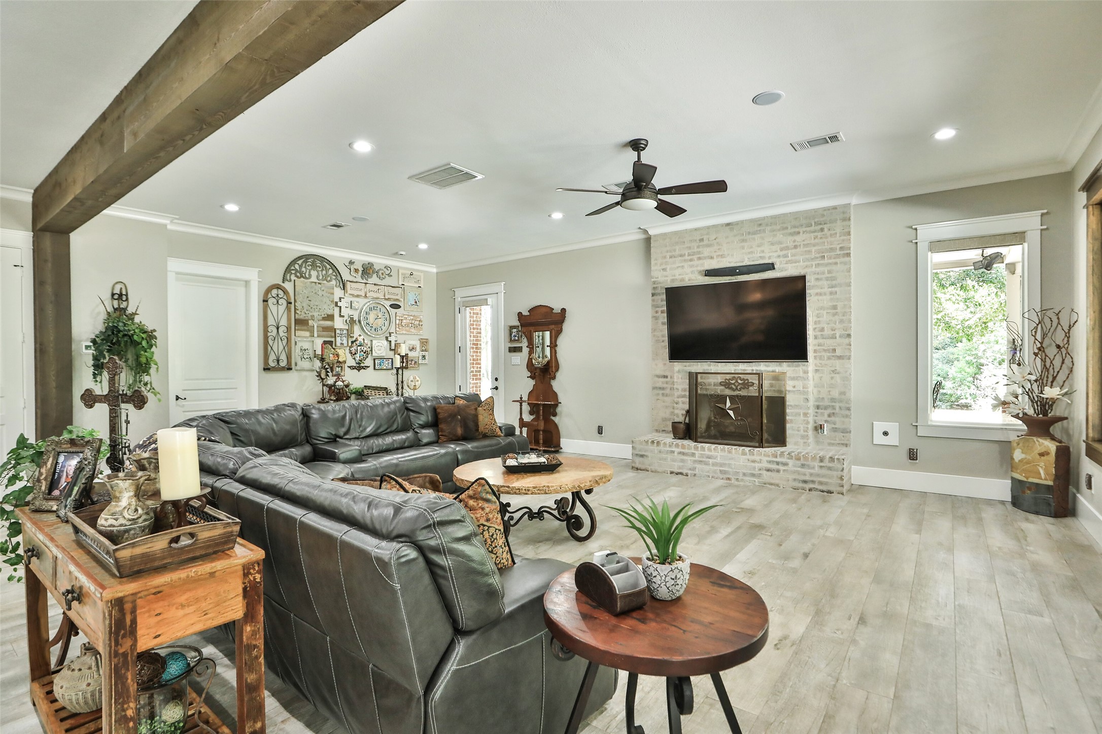 12126 Zion Road Tomball, TX 77375 - Photo 14 of 45 This spacious living room features a beautiful gas brick fireplace, that is bright and airy, with recessed lighting, a ceiling fan, large windows providing plenty of natural light.