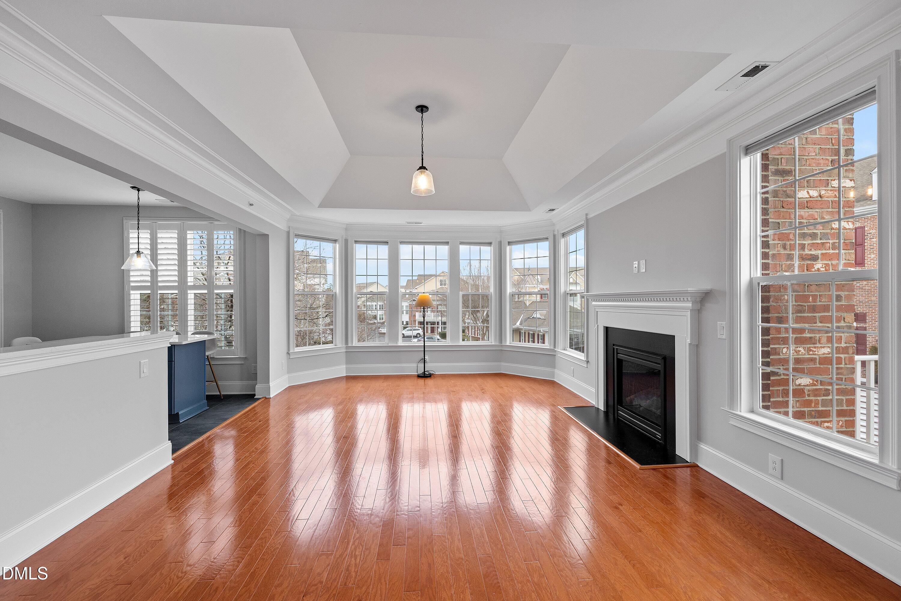 9211 Calabria Drive, Unit 205 Raleigh, NC 27617 - Photo 12 of 55 a view of an empty room with wooden floor and a window