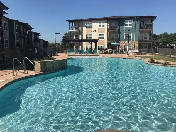 a swimming pool view with a outdoor seating space