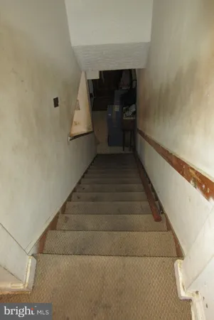 a view of a hallway with workspace and a window