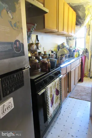 a room with water heater and wooden cabinets