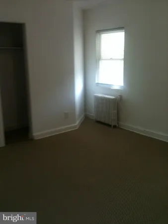 a kitchen with a sink a stove cabinets and a window