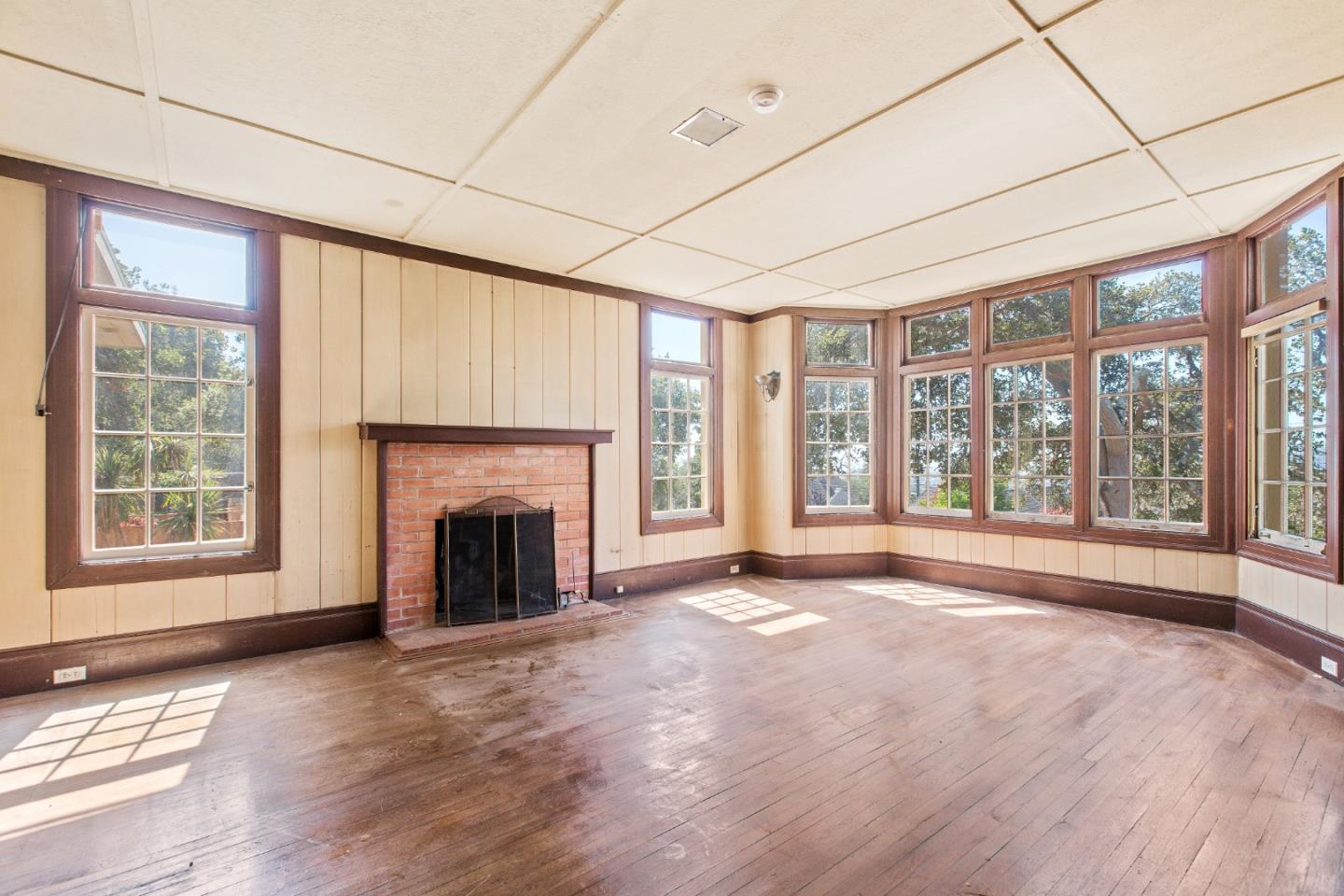 585 Santa Rosa Avenue Berkeley, CA 94707 - Photo 13 of 71 a view of an empty room with a fireplace and a window