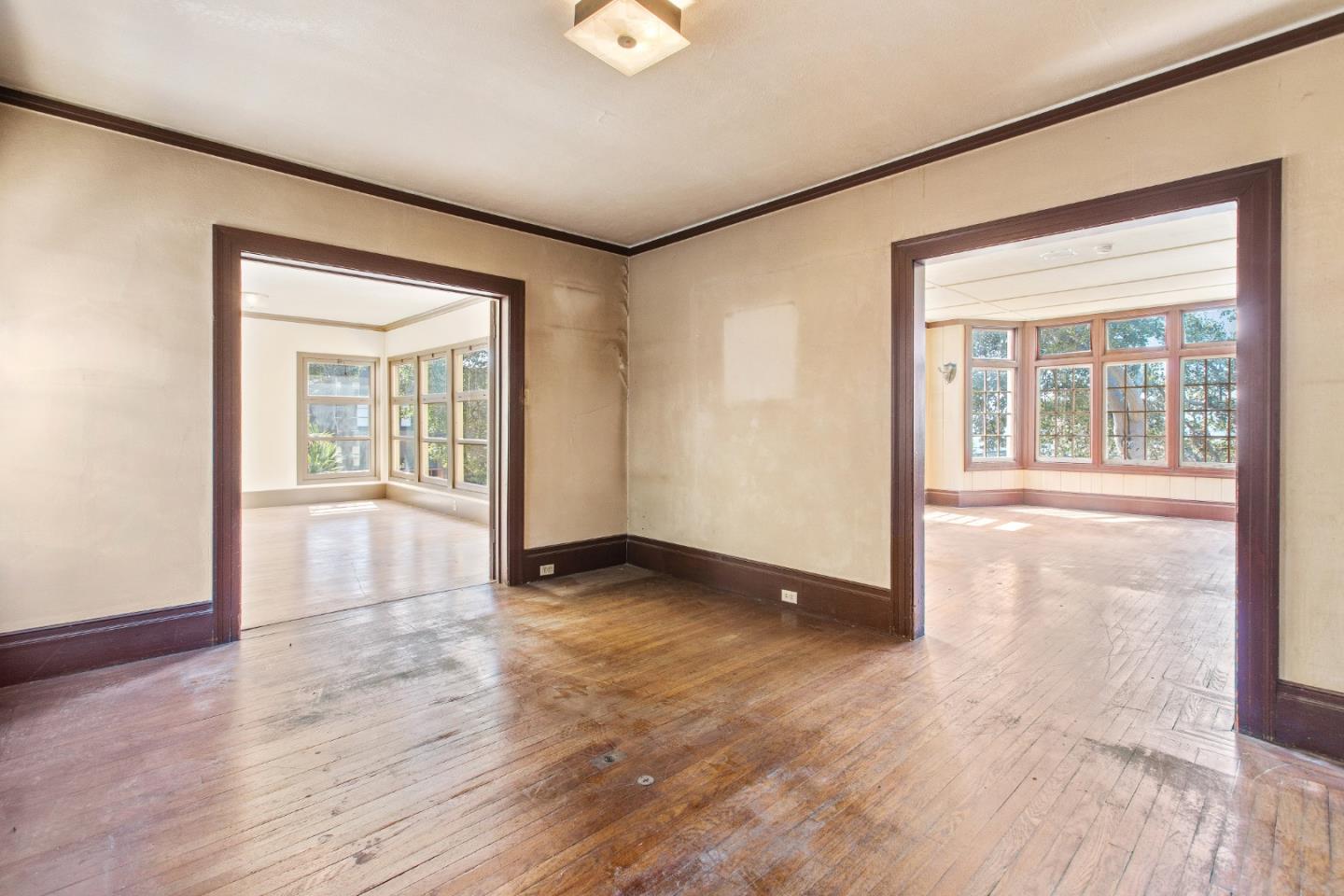 585 Santa Rosa Avenue Berkeley, CA 94707 - Photo 17 of 71 a view of an empty room with wooden floor and a window