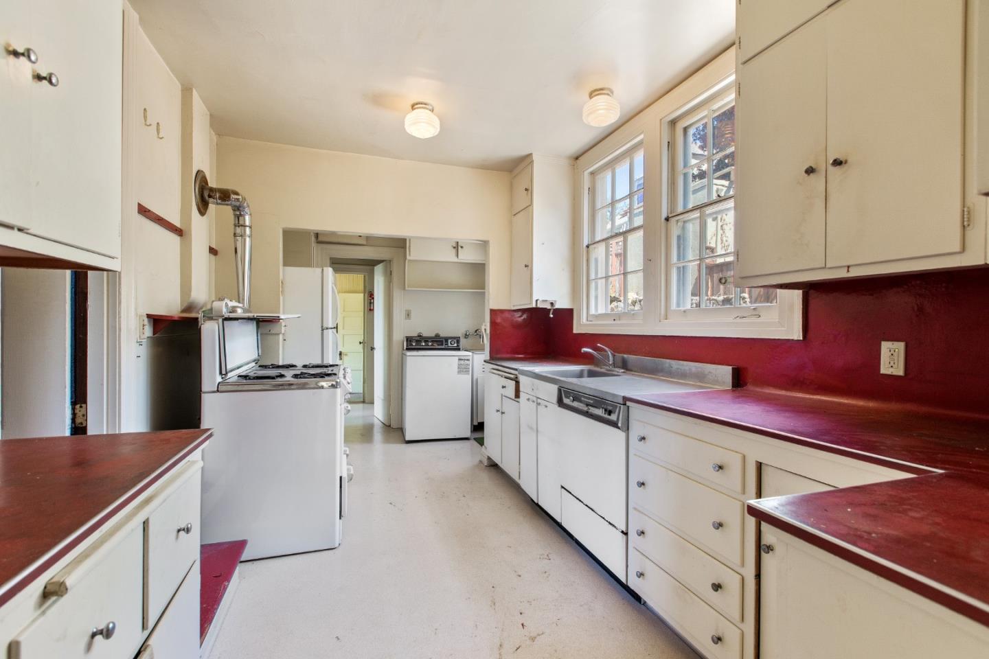 585 Santa Rosa Avenue Berkeley, CA 94707 - Photo 22 of 71 a kitchen with granite countertop a sink stainless steel appliances and cabinets