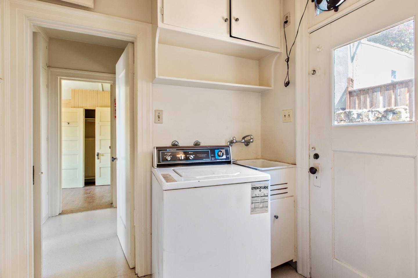 585 Santa Rosa Avenue Berkeley, CA 94707 - Photo 25 of 71 a view of washer and dryer with kitchen in the background