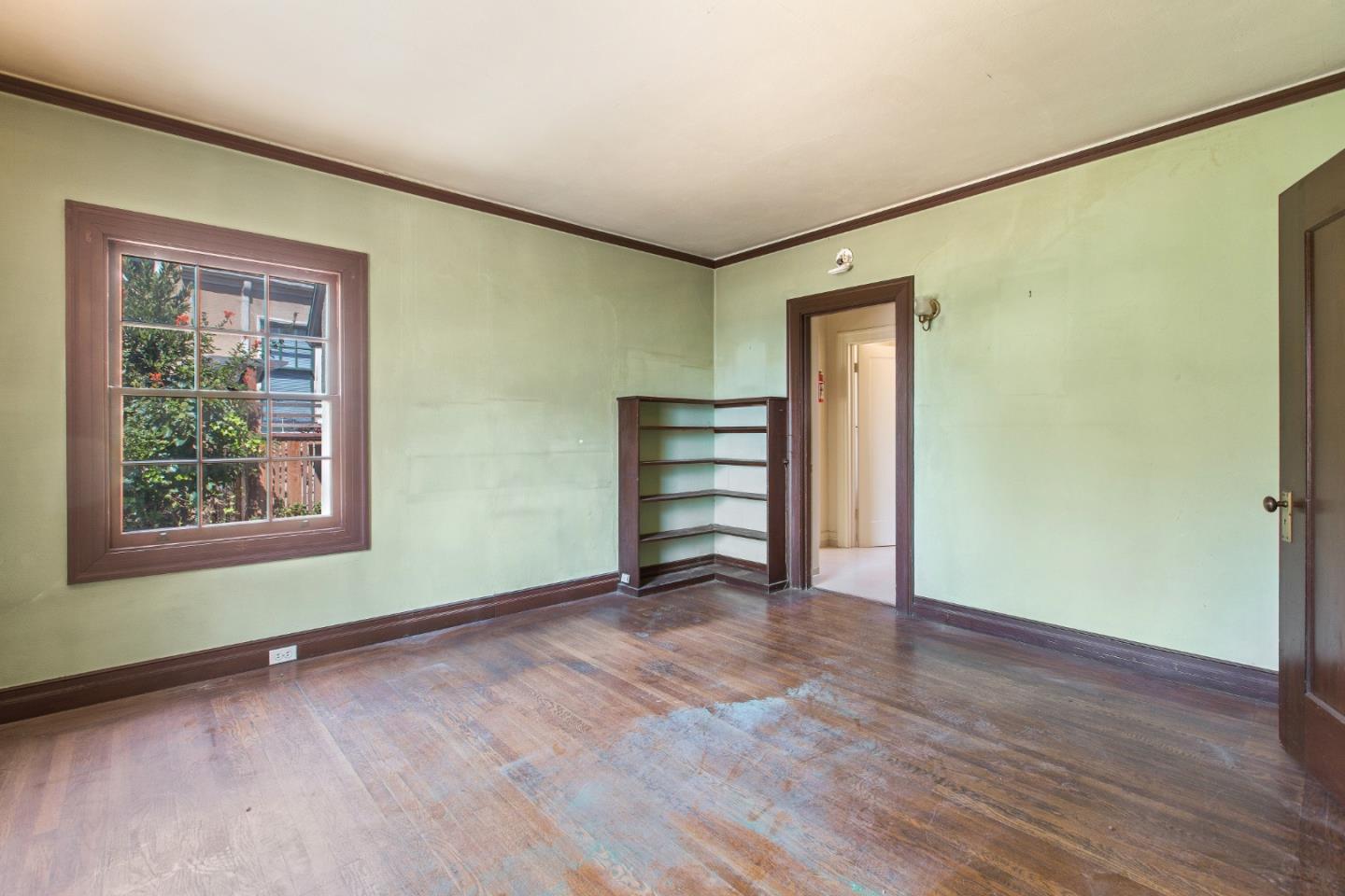 585 Santa Rosa Avenue Berkeley, CA 94707 - Photo 26 of 71 a view of an empty room with wooden floor and a window