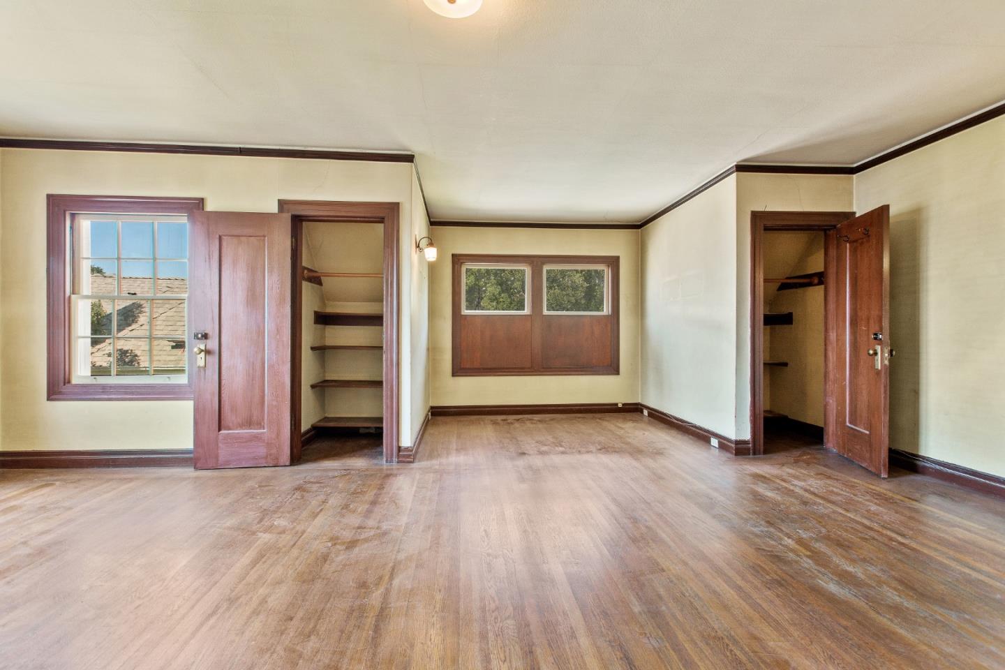 585 Santa Rosa Avenue Berkeley, CA 94707 - Photo 32 of 71 a view of an empty room with a window and wooden floor