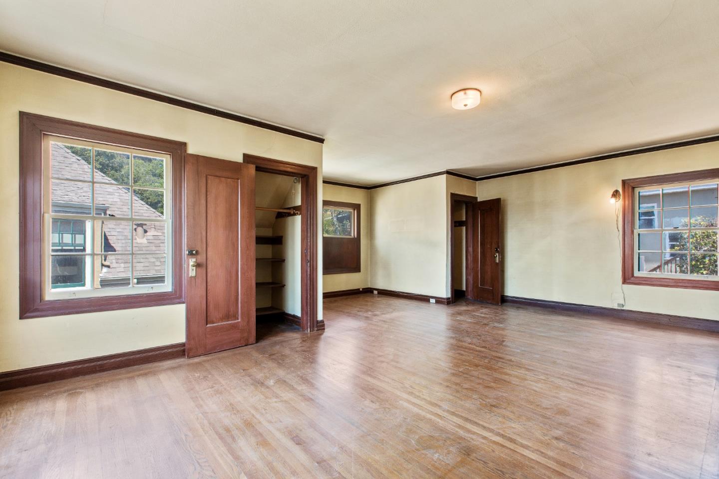 585 Santa Rosa Avenue Berkeley, CA 94707 - Photo 33 of 71 a view of an empty room with a window and wooden floor