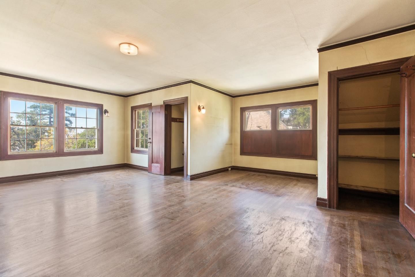 585 Santa Rosa Avenue Berkeley, CA 94707 - Photo 36 of 71 a view of an empty room with a window and wooden floor