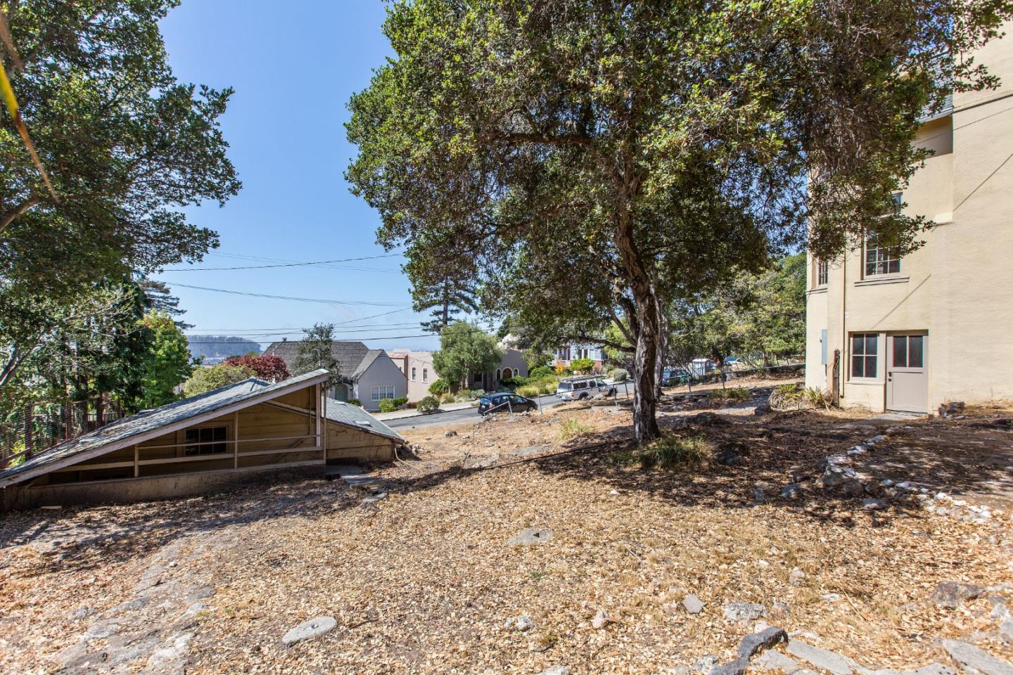 585 Santa Rosa Avenue Berkeley, CA 94707 - Photo 10 of 71 a backyard of a house with barbeque oven table and chairs