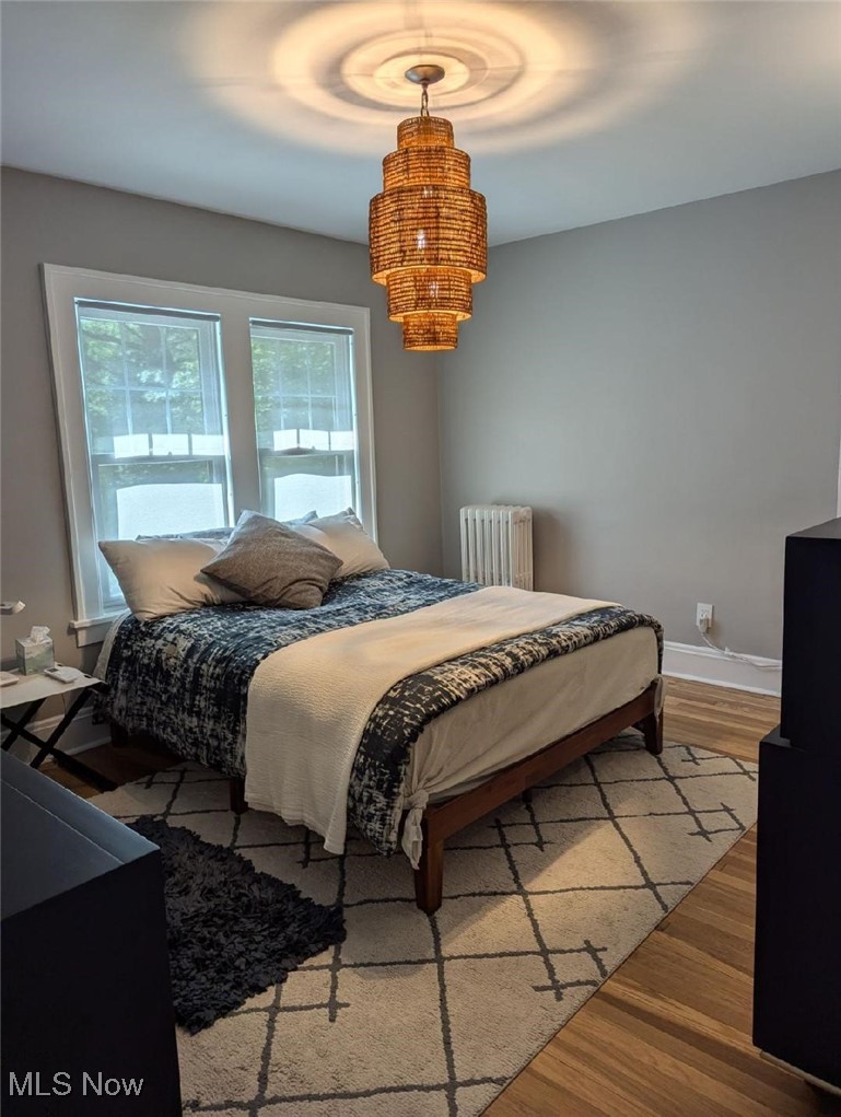2624 Lee Road Cleveland, OH 44118 - Photo 34 of 50 Bedroom with radiator heating unit and hardwood floors and ratan chandelier.