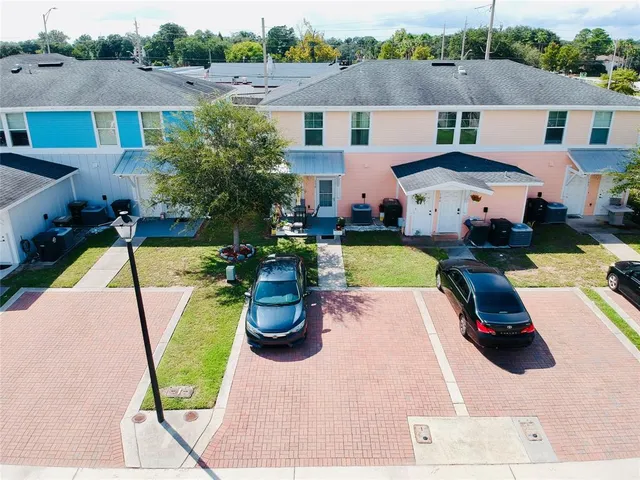 an aerial view of a house with a garden and lake view