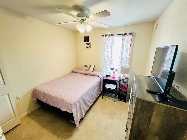 a bedroom with a bed and a flat screen tv