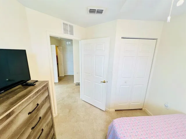 a bedroom with a bed and a walk in closet