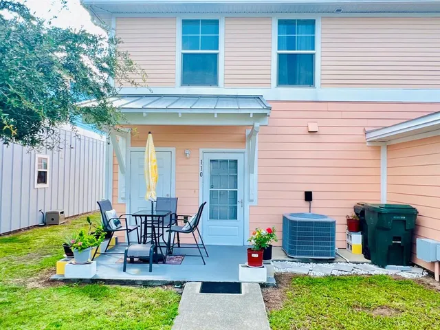 an aerial view of a house with a yard swimming pool outdoor seating