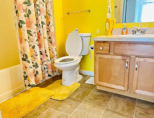 a bathroom with a shower curtain and a shower curtain