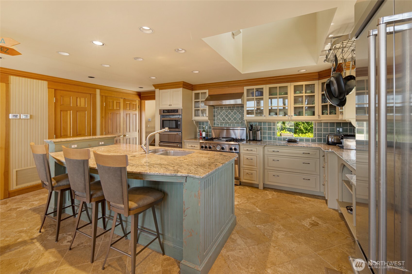 170 Weeks Point Way Lopez Island, WA 98261 - Photo 11 of 36 a kitchen with stainless steel appliances kitchen island granite countertop a table and chairs