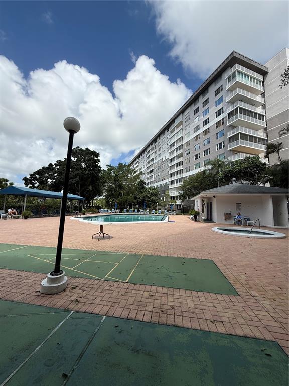 4001 Hillcrest Drive, Unit 1012 Hollywood, FL 33021 - Photo 13 of 14 a front view of a house with a yard