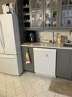 a kitchen with granite countertop a sink a stove and a refrigerator