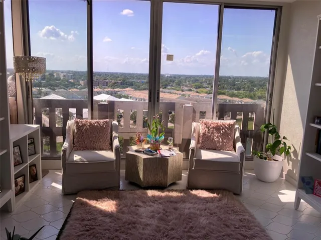 a living room with furniture city view and a floor to ceiling window