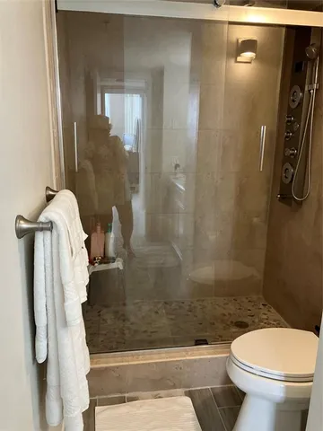 a bathroom with a shower and toilet