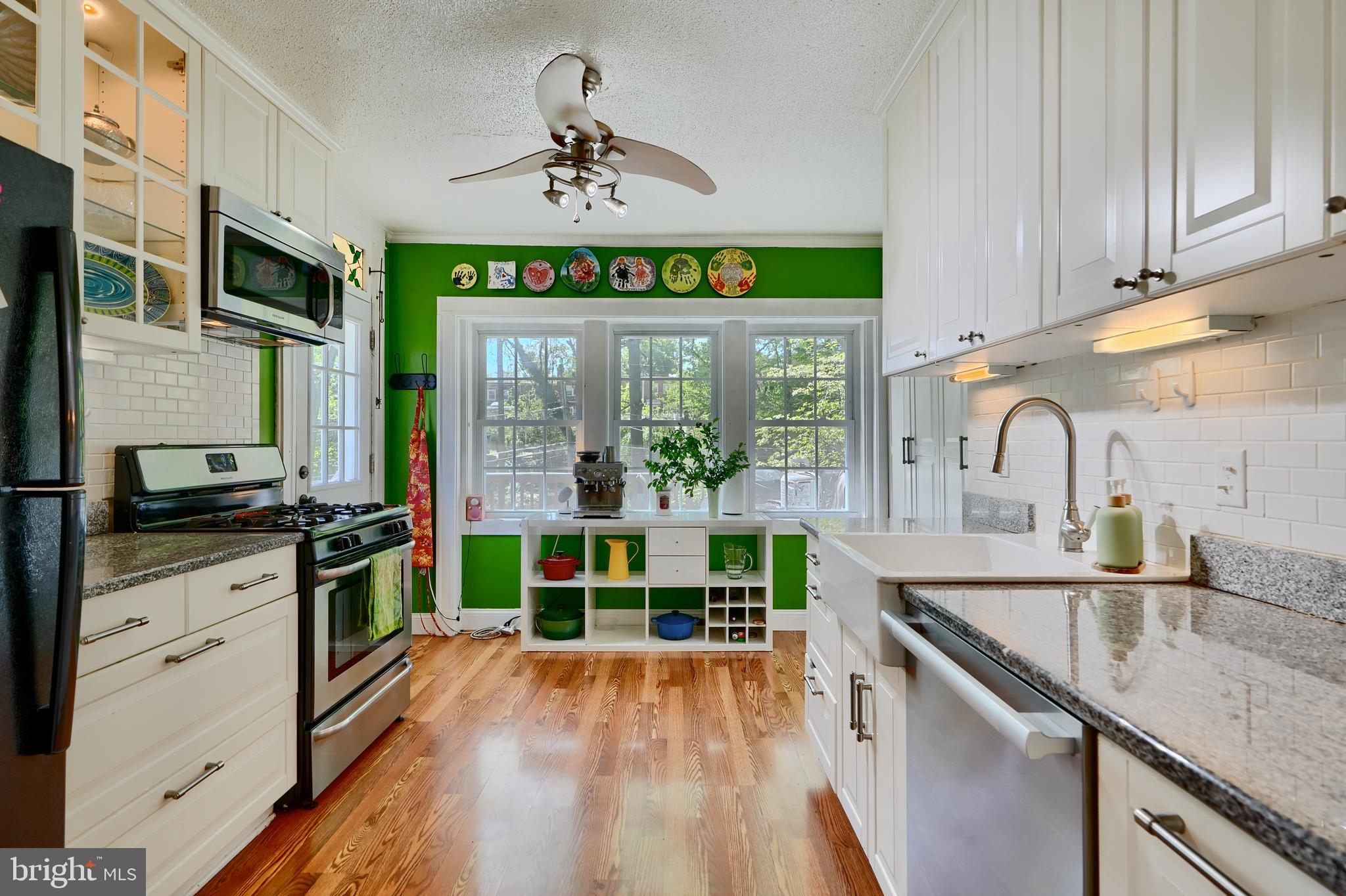 1111 Overbrook Road Baltimore, MD 21239 - Photo 11 of 47 a kitchen with kitchen island granite countertop a stove a sink and a refrigerator