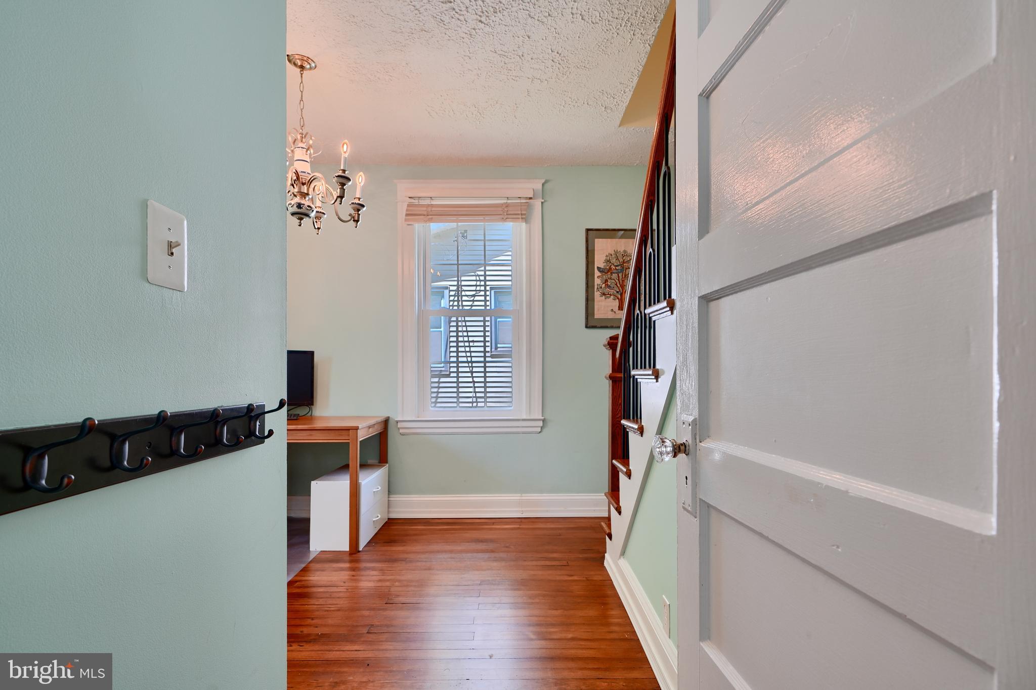 1111 Overbrook Road Baltimore, MD 21239 - Photo 18 of 47 a view of hallway with wooden floor and stairs