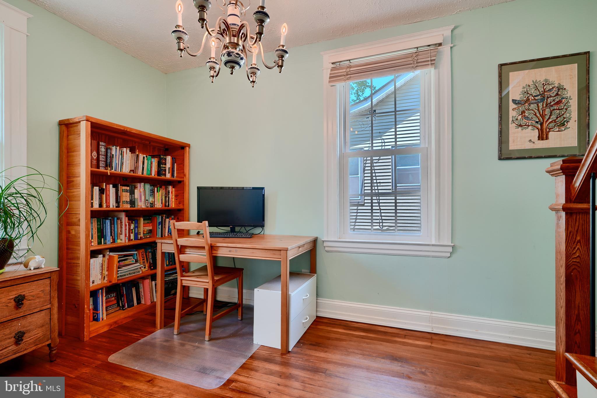 1111 Overbrook Road Baltimore, MD 21239 - Photo 19 of 47 a view of a workspace with furniture and a bookshelf