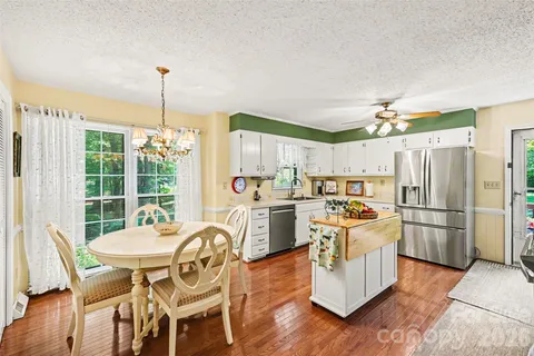 a kitchen with appliances cabinets and wooden floor