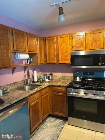 a kitchen with a sink stove and microwave