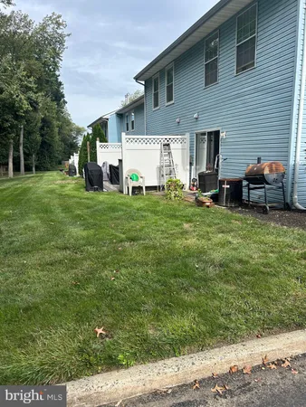 a view of a house with a yard and sitting area