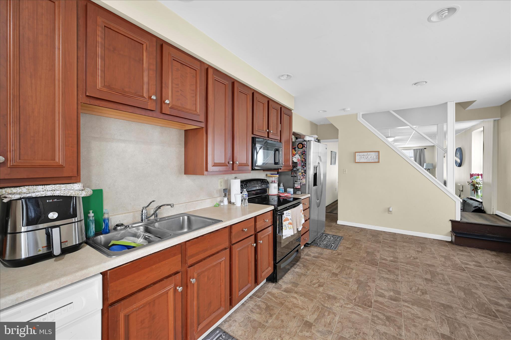 942 Pike Street Reading, PA 19604 - Photo 14 of 27 a kitchen with stainless steel appliances granite countertop a sink stove and cabinets