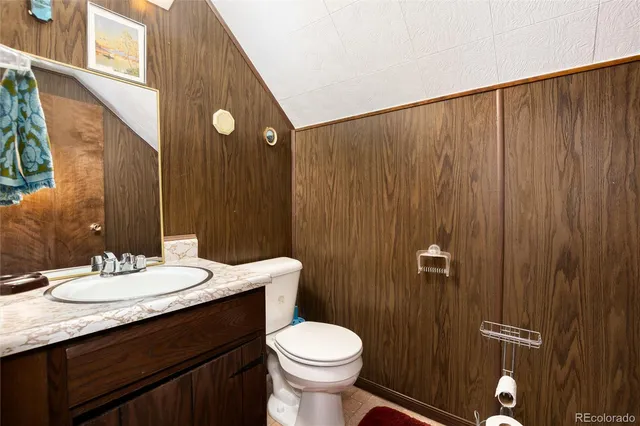 a bathroom with a sink a toilet and shower curtain