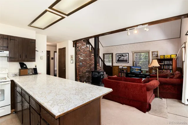 a kitchen with sink cabinets and living room view