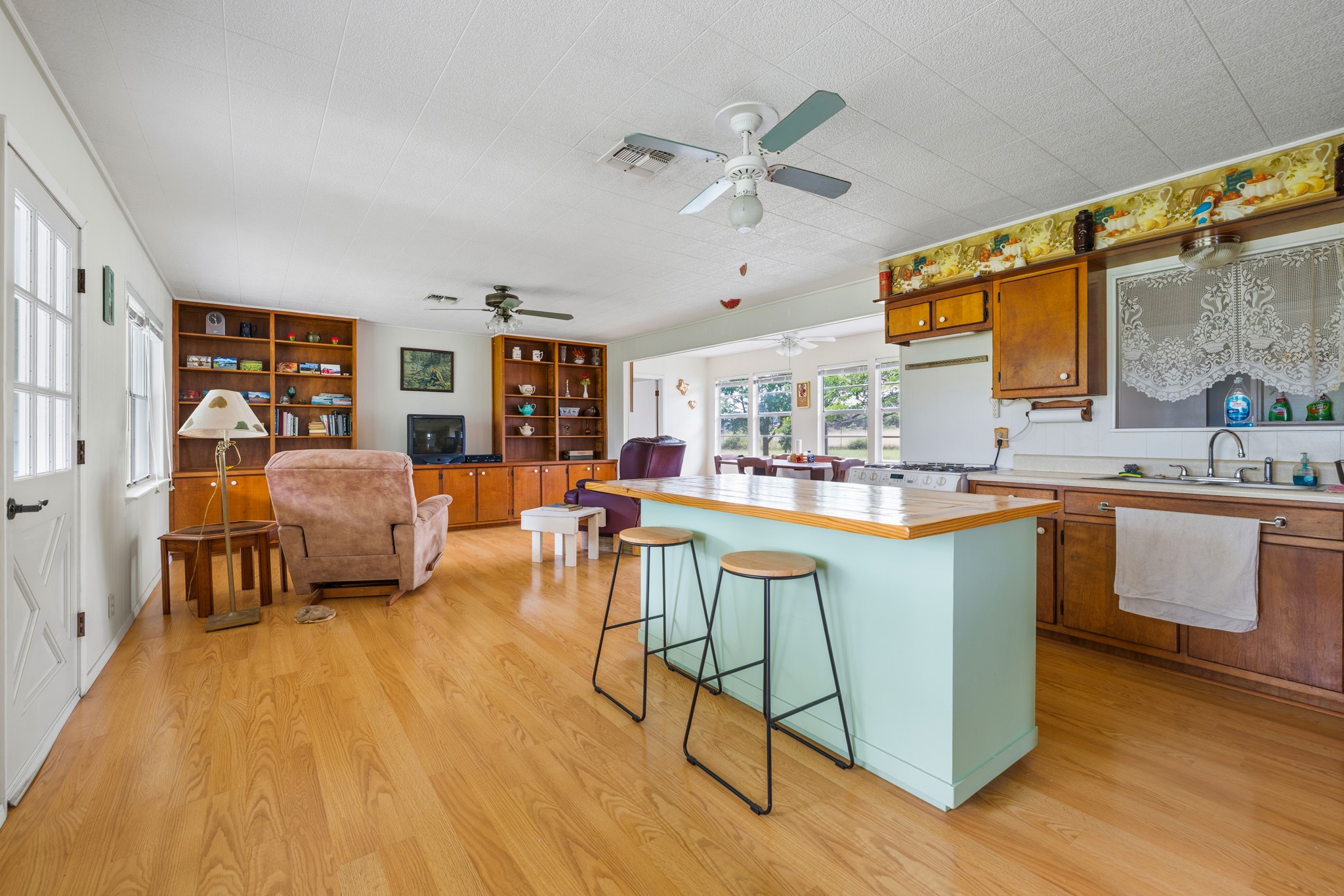 341 River View Road Fredericksburg, TX 78624 - Photo 11 of 40 Gleaming hardwood floors and a spacious kitchen island anchor this open-concept layout.