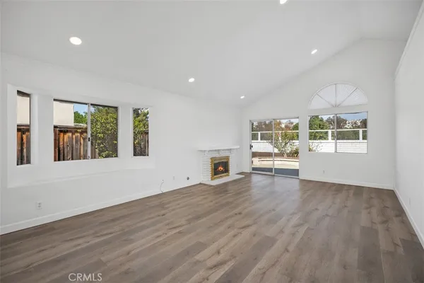 a view of a livingroom with wooden floor and white walls