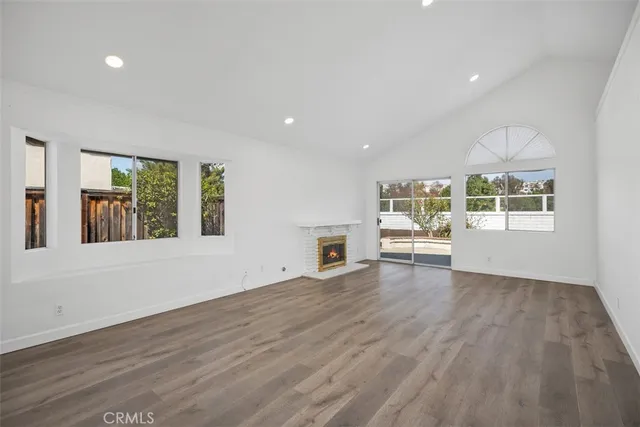 a view of a livingroom with wooden floor and white walls