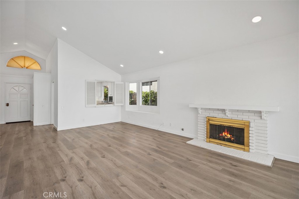 28222 Via Alfonse Laguna Niguel, CA 92677 - Photo 4 of 10 an empty room with wooden floor fireplace and windows