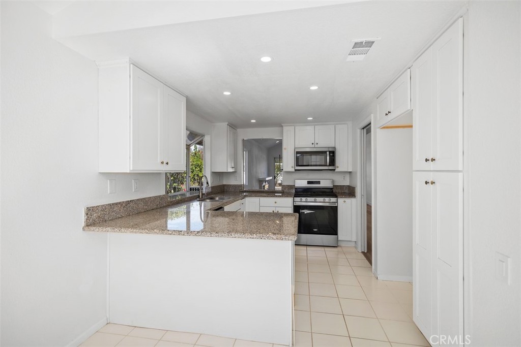28222 Via Alfonse Laguna Niguel, CA 92677 - Photo 5 of 10 a kitchen with stainless steel appliances granite countertop a refrigerator sink and stove