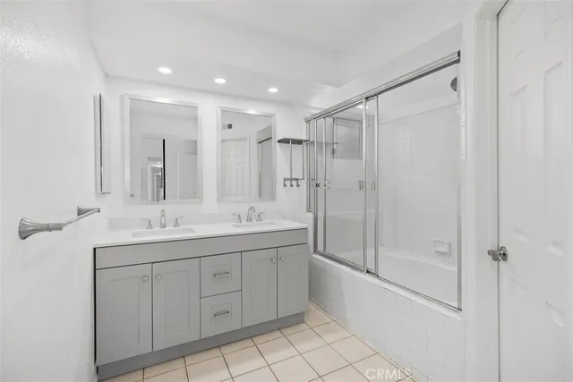 a bathroom with a granite countertop sink mirror and shower