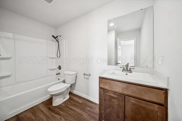 a bathroom with a sink toilet a mirror and shower