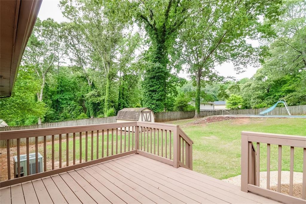 1291 Stephens Street Southwest Lilburn, GA 30047 - Photo 5 of 22 a view of a wooden deck and a yard