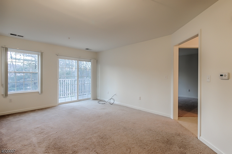 2889 Highway 10, Unit 1310 Morris Plains, NJ 07950 - Photo 4 of 16 an empty room with windows