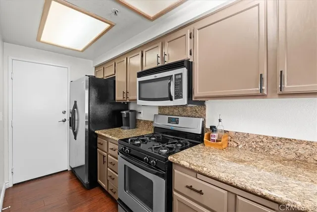 a kitchen with a stove microwave and refrigerator