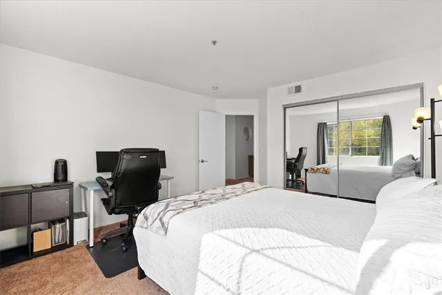 a bedroom with a bed and chair