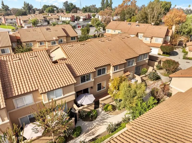 an aerial view of a house with a yard