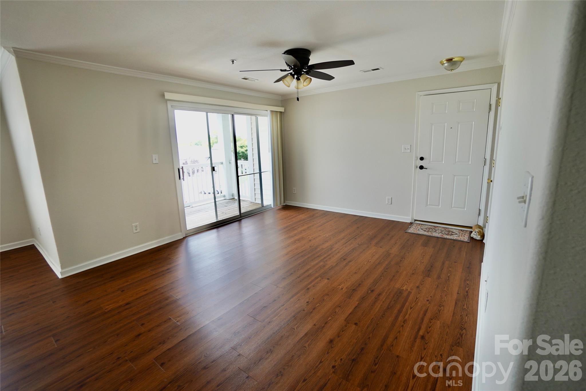 4010 Town Center Road Harrisburg, NC 28075 - Photo 12 of 17 a view of an empty room with wooden floor and a window
