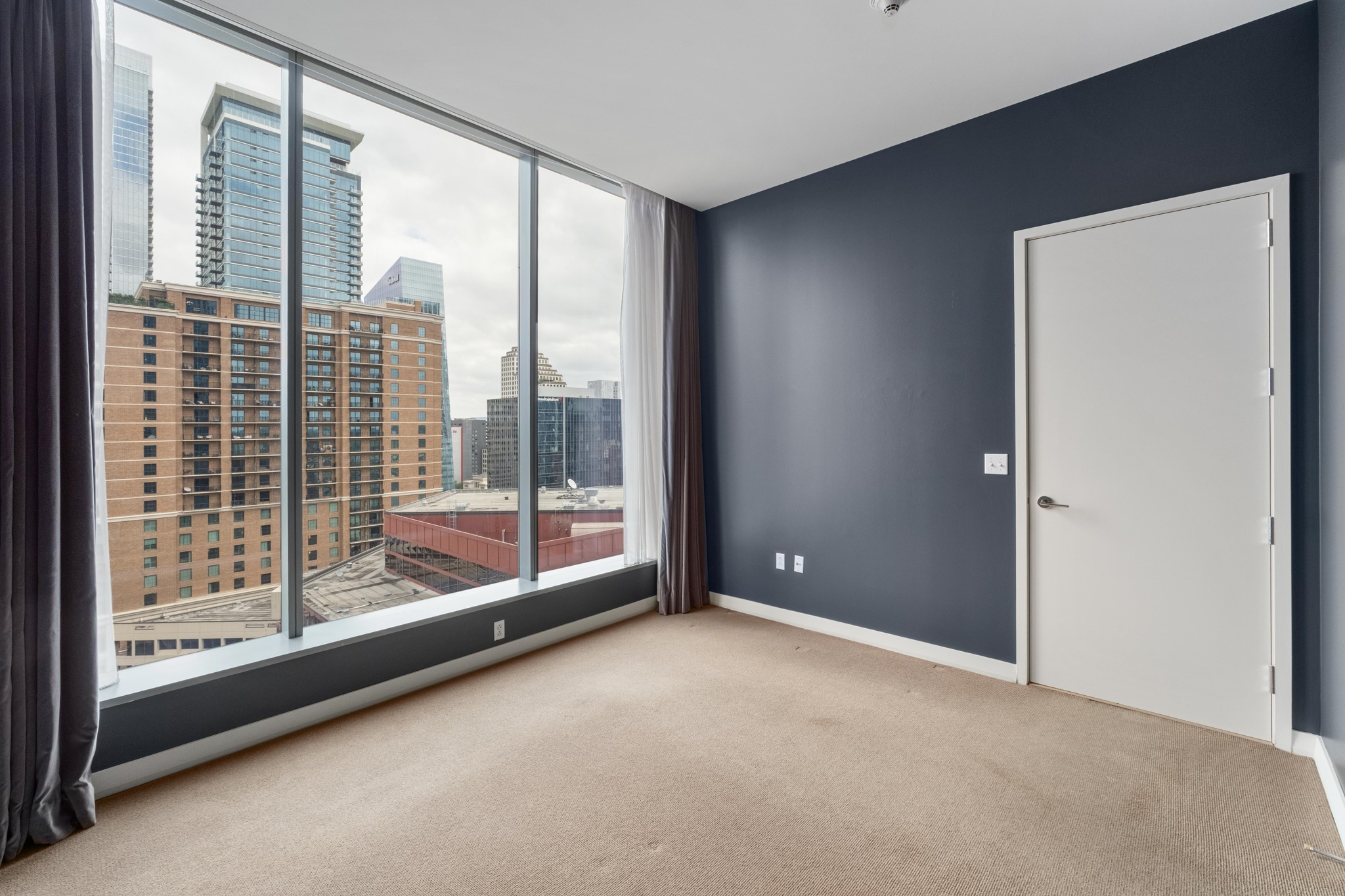210 Lavaca Street, Unit 1810 Austin, TX 78701 - Photo 11 of 28 Spare room featuring light carpet and a city view