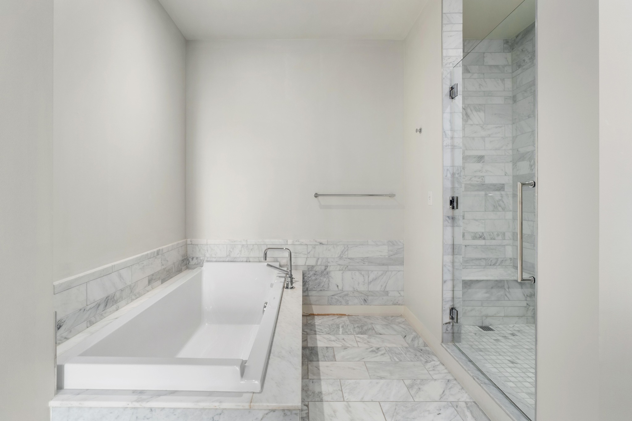 210 Lavaca Street, Unit 1810 Austin, TX 78701 - Photo 15 of 28 Bathroom featuring a bath and a marble finish shower